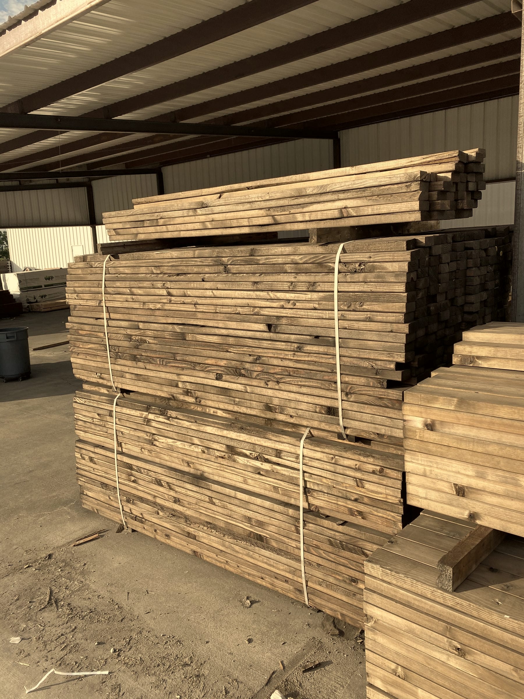 Bundled Western Red Cedar pickets stacked at the A+ Fence Company yard